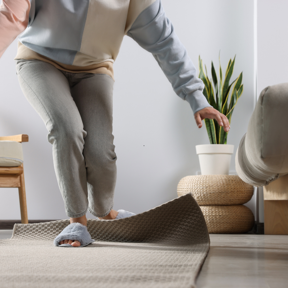 Elderly person losing balance on rug edge, showing importance of fall prevention in skilled nursing care.