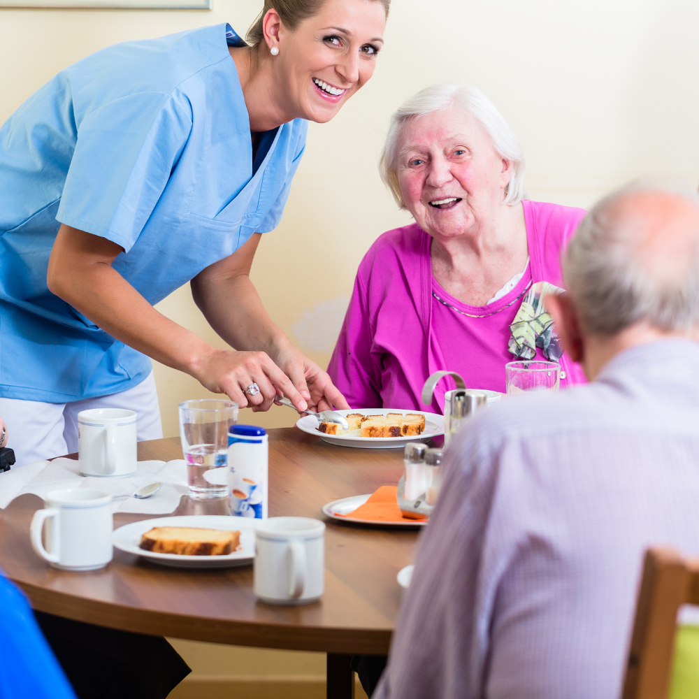 Nurse and resident sharing a smile at Ashford Hall nursing facility.